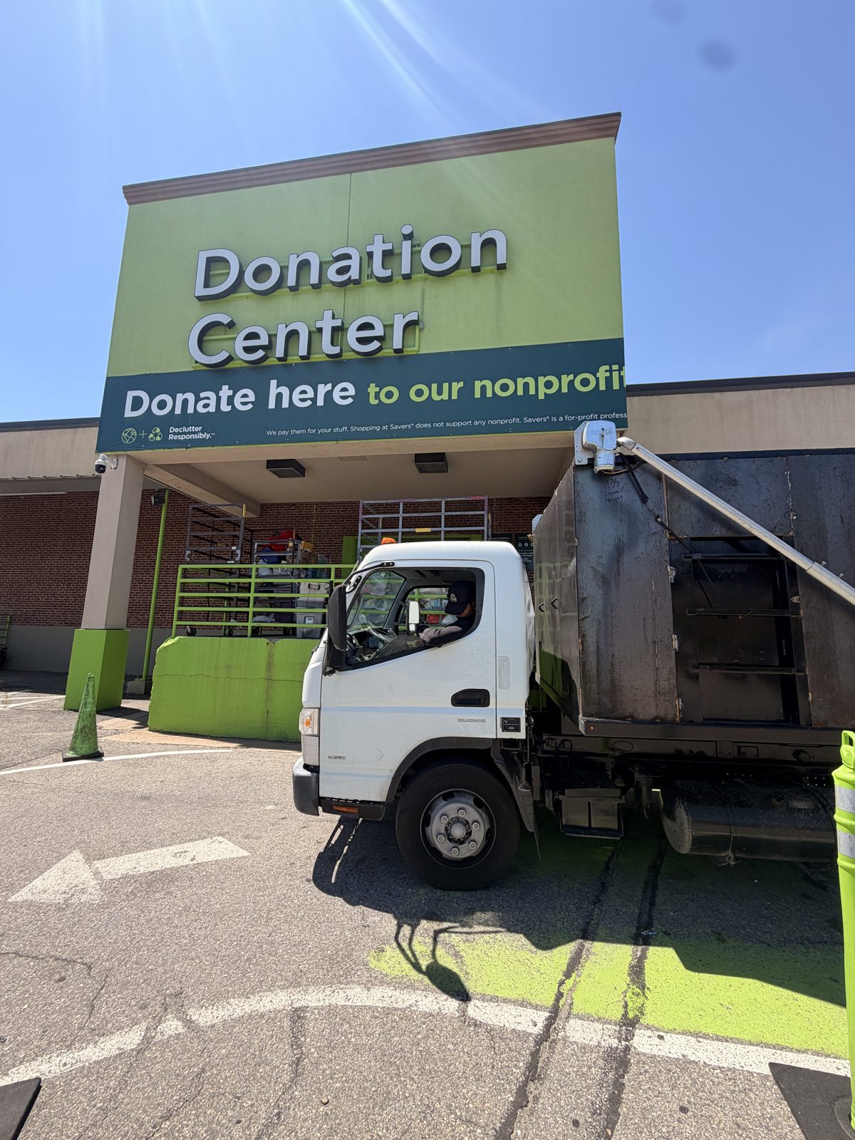 The company truck unloading donated items at a local donation center